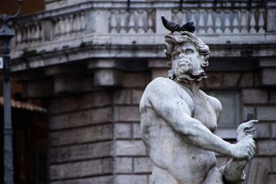 Low angle view of statue against building