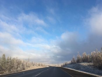 Country road against sky