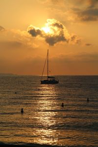 Silhouette sailboat on sea against sky during sunset