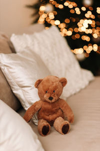 Close-up of teddy bear on bed