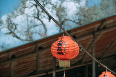 Low angle view of lantern hanging on building