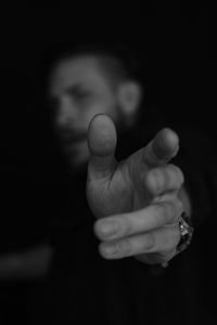 Close-up of baby hand against black background