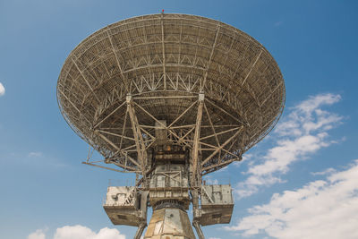 Low angle view of communications tower against sky