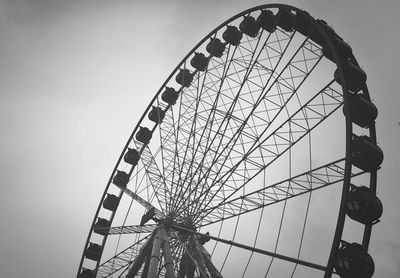 Low angle view of ferris wheel against sky