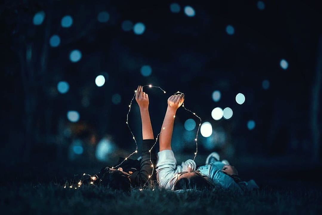 night, one person, leisure activity, real people, young adult, full length, lifestyles, enjoyment, adult, arts culture and entertainment, lying down, illuminated, arms raised, music, women, event, music festival, casual clothing, fun, human arm, nightlife, festival, popular music concert, excitement