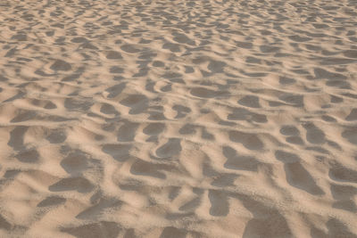 High angle view of footprints on sand at beach