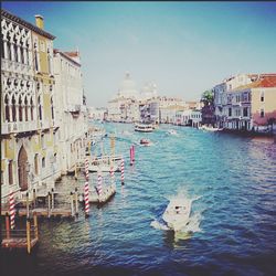 Boats in canal with buildings in background