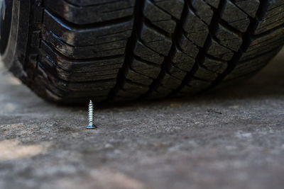 Close-up of nail by tire