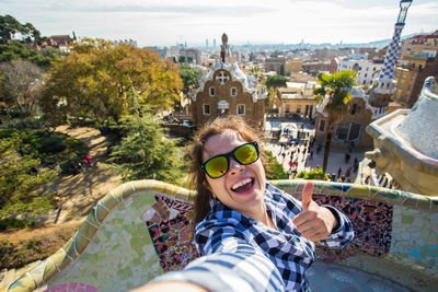 Portrait of smiling young woman in city