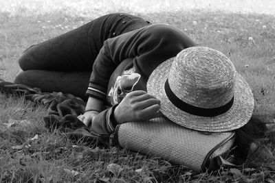 Rear view of girl sitting on field