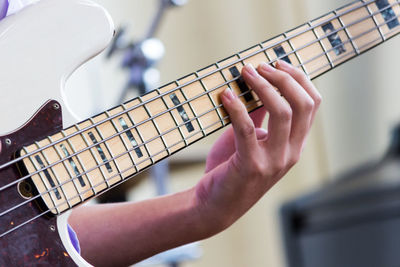 Close-up of man playing guitar