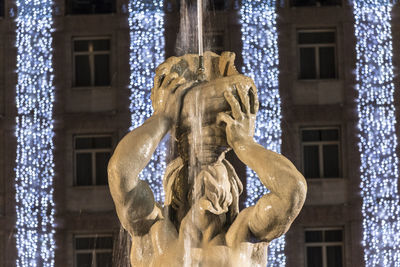 Low angle view of statue against historic building