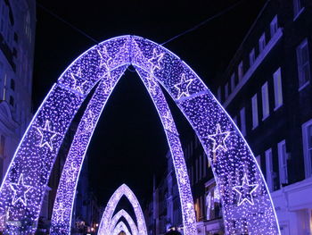 Low angle view of illuminated building at night