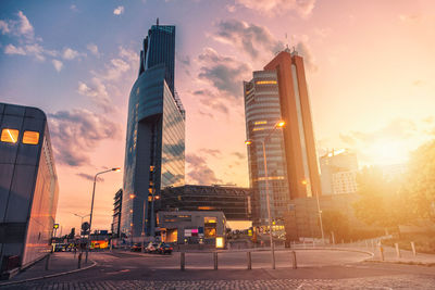 Low angle view of skyscrapers against sky during sunset