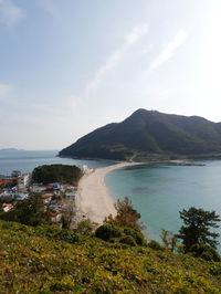 Scenic view of sea and mountains against sky