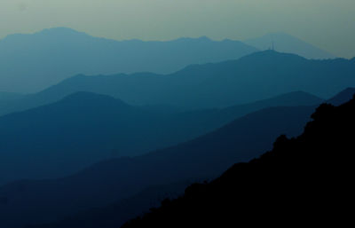 Scenic view of silhouette mountains against clear sky