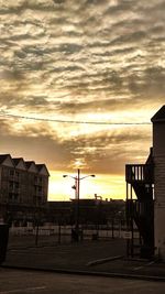 Built structure against cloudy sky at sunset