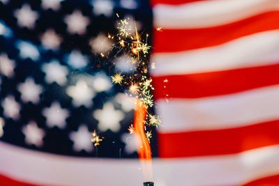 Full frame shot of american flag with sparkler