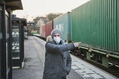 Full length of man standing on railroad tracks during winter