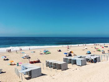 Scenic view of beach against clear blue sky