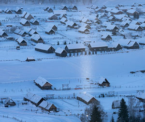 High angle view of snow covered houses by building