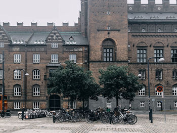 Bicycles on street against buildings in city, copenhagen city hall