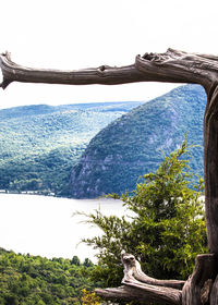 Scenic view of sea and mountains against clear sky
