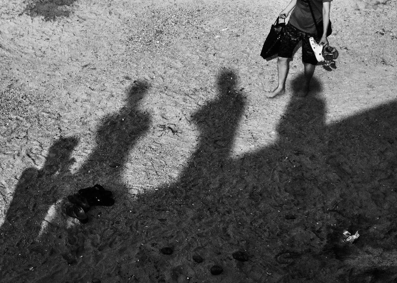 lifestyles, shadow, high angle view, leisure activity, men, togetherness, low section, sunlight, unrecognizable person, person, focus on shadow, sand, bonding, street, walking, outdoors