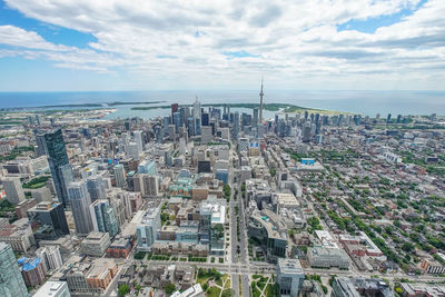 Aerial view of cityscape against cloudy sky