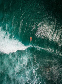 High angle view of man swimming in sea