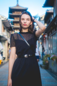 Beautiful young woman standing at home