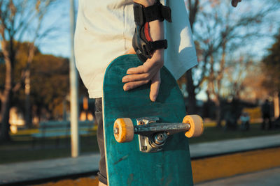 Low section of skateboarder wearing protective equipment