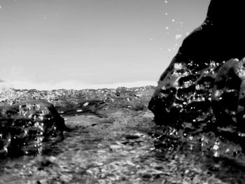 Close-up of rock on land against sky