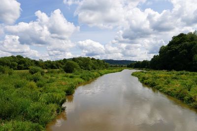 Scenic view of green landscape against sky