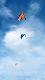 Low angle view of paragliding against sky