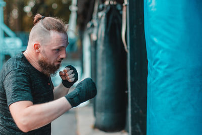 Young man boxing at gym