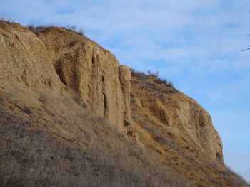 Low angle view of rock formations against sky