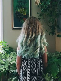 Rear view of girl standing against tree