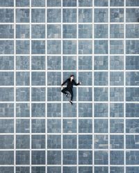 Directly above shot of man sleeping on tiled floor