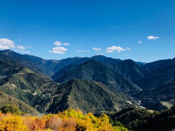 Scenic view of mountains against blue sky