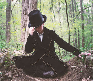 Full length of woman wearing hat in forest