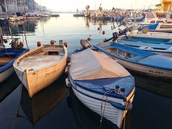 Close-up of boats moored on beach against sky