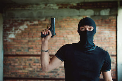 Mid adult man standing against blurred background