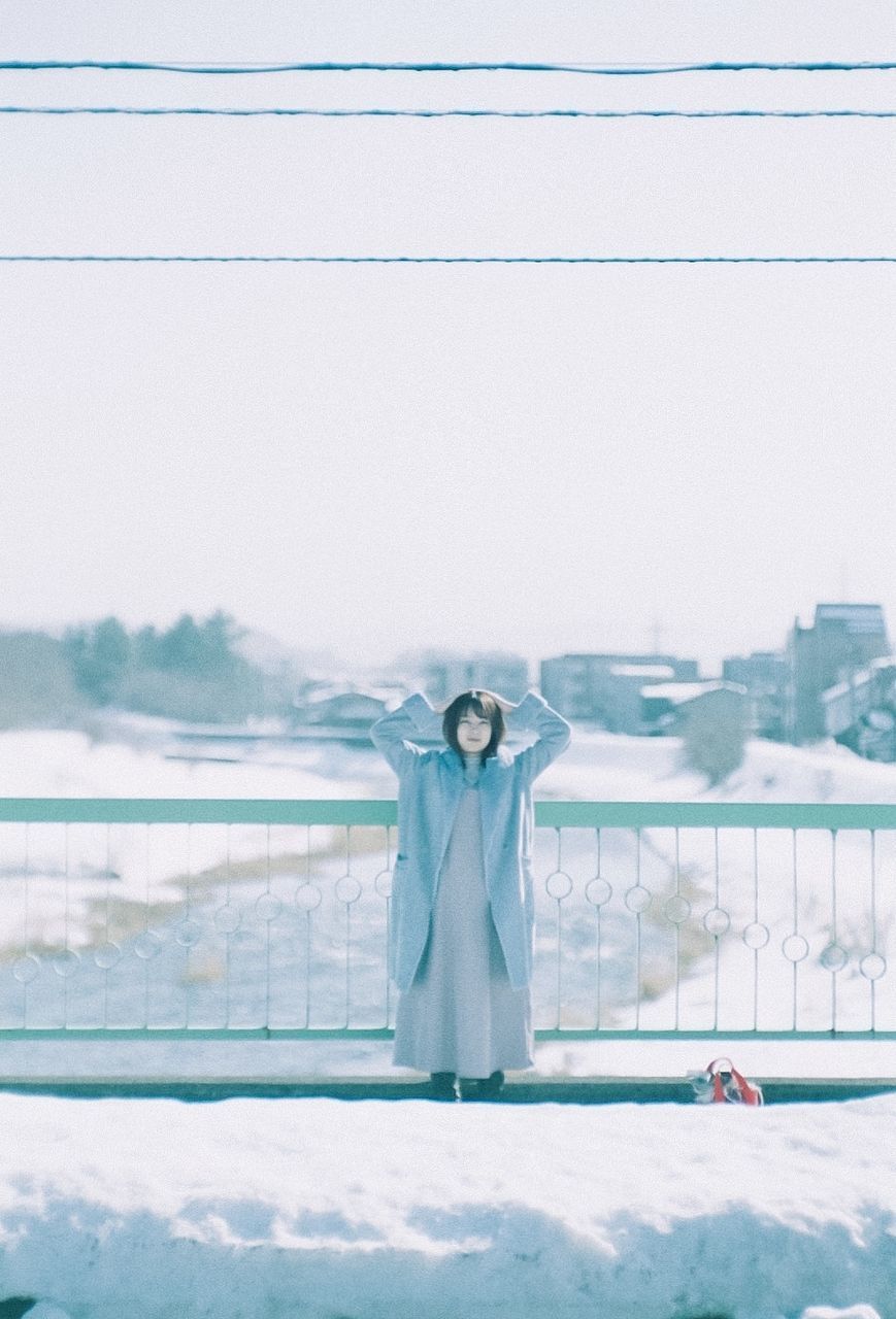 PORTRAIT OF PERSON STANDING IN SNOW