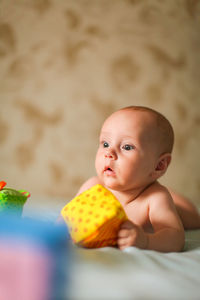 Cute baby boy lying on bed