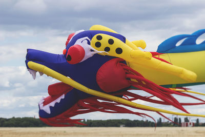 Close-up of yellow toy in the sky