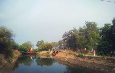 Reflection of trees in lake against sky