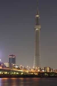 Illuminated cityscape against sky at night