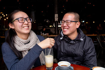 Portrait of a smiling young woman in restaurant