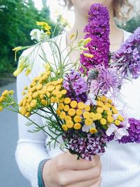 Close-up of woman holding bouquet of flowers
